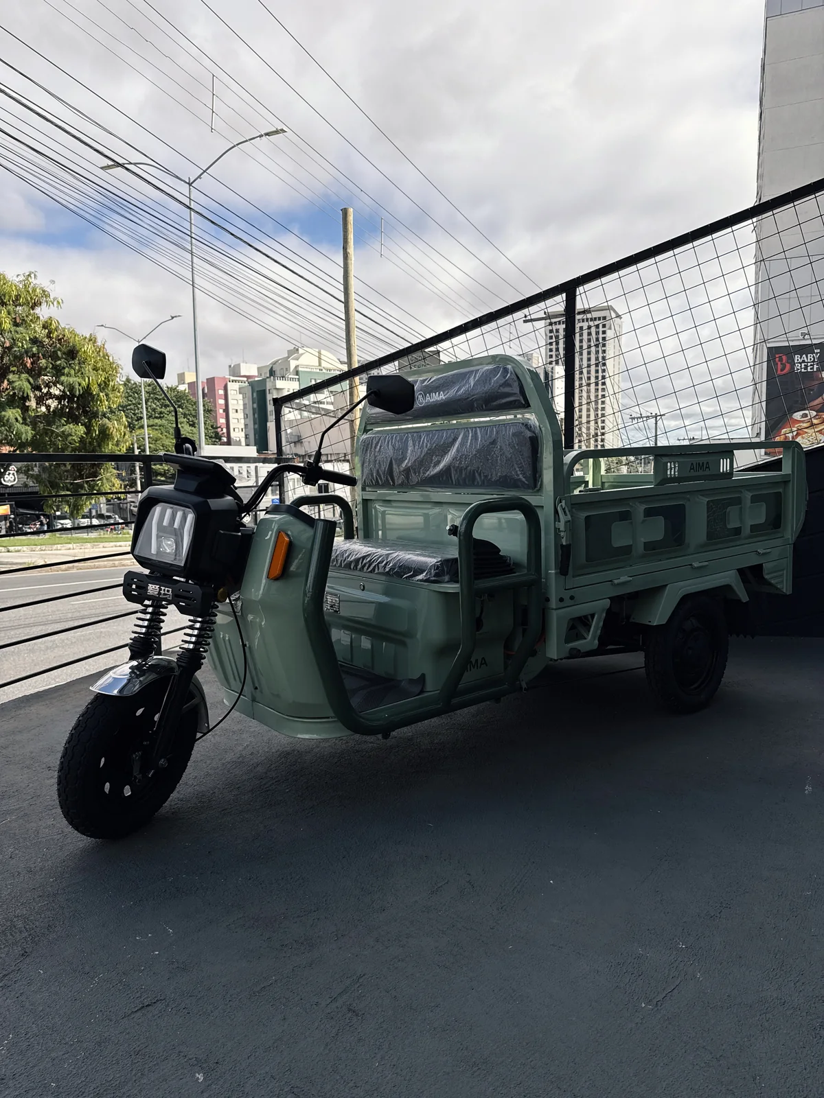 AIMA Tank verde visto de lado, com a caçamba abaixada